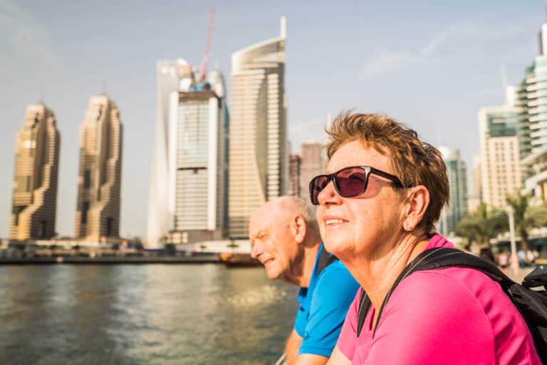 Senior couple enjoying city skyline by the water.